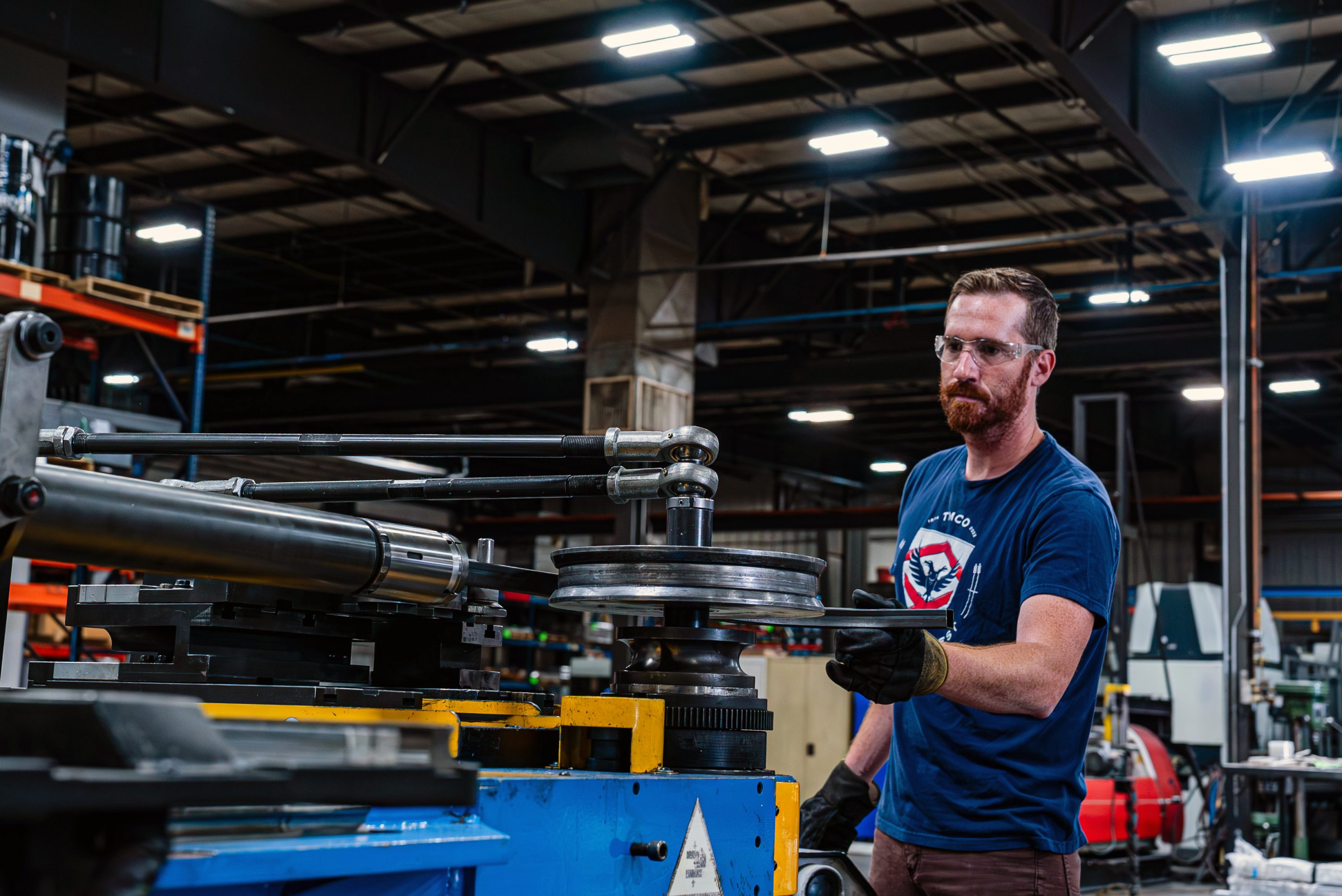 TMCO employee using tube bender machine.